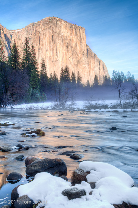 Snow-covered rocks provide the foreground for this winter view of El Capitan reflected in the Merced River. Photo by Tom Jewett...