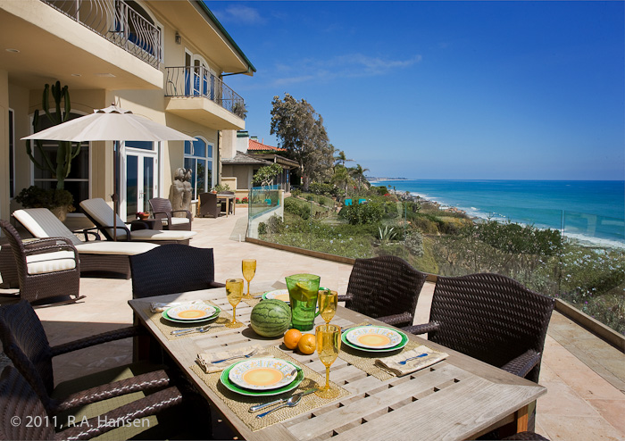 Patio dining at an elegant residence with ocean view. For more residential and commercial architecture images, please visit Robert...