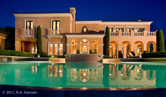 An illuminated pool enhances the evening view from this elegant residence. For more residential and commercial architecture images...