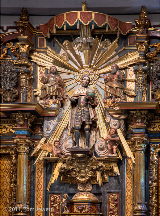 Retablo Detail -- In an extremely ornate baroque style, San Fernando (King Ferdinand III of Castile) is shown with both royal...