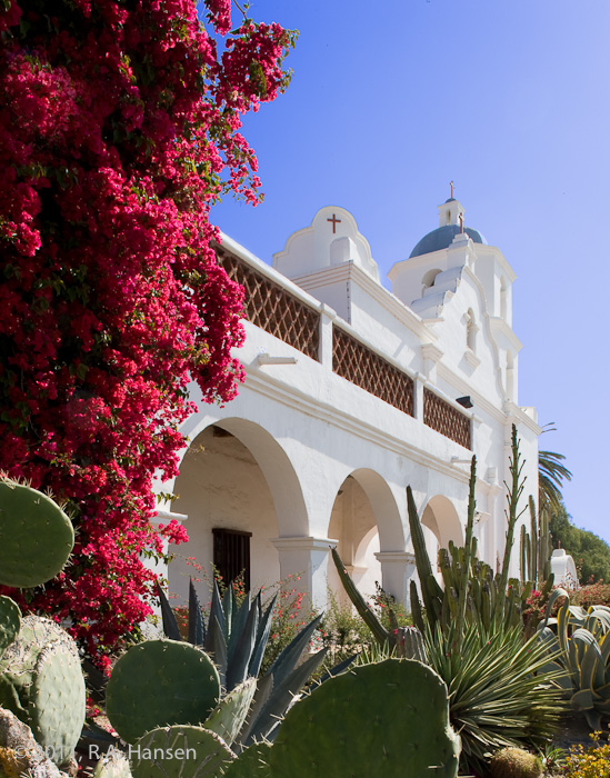 Garden and fa&ccedil;ade, view #1 -- This mission is not only an active parish church, it is a major educational and retreat...