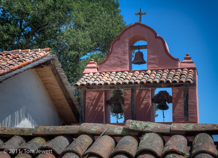 Campanario -- View from the back (west) side of the mission complex; the tile roof in the foreground tops the cemetery wall....