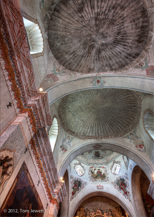 Interior view, looking to the richly decorated ceiling. Unlike the flat structure of most California mission churches, this one...