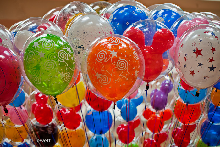 Bright orange and green, as well as elaborate designs, attract children young and old at this vendor's display. Photo by Tom...